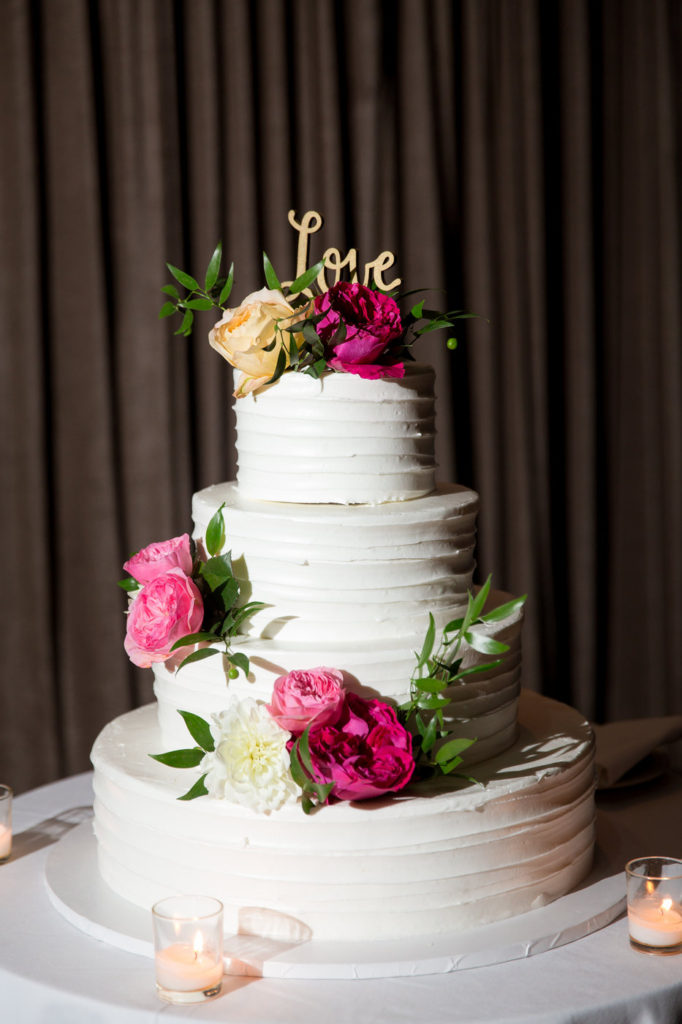 buttercream cake with fuschia and pink florals statuesque events