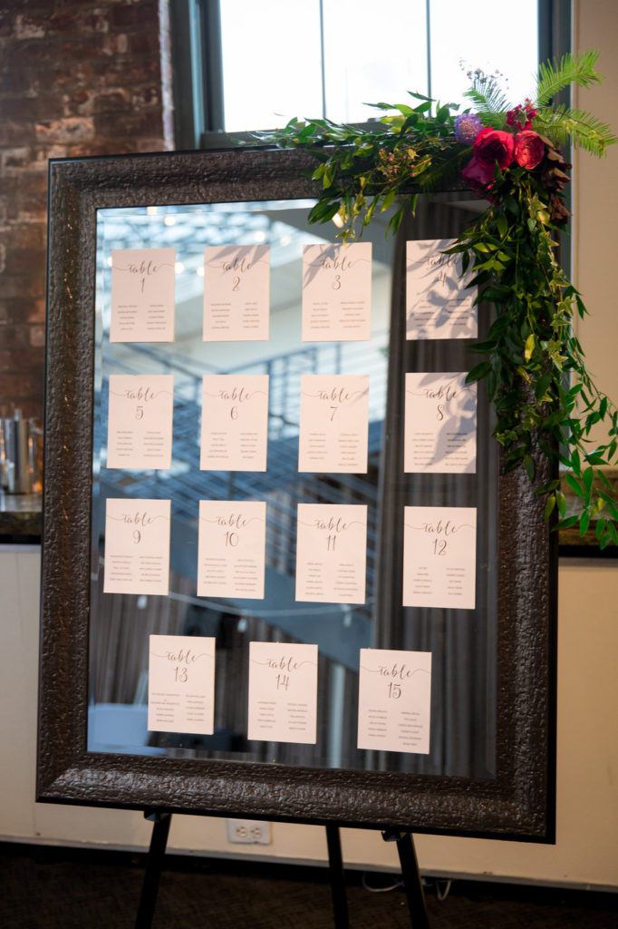 mirror seating chart with greenery decor new york wedding planner statuesque events
