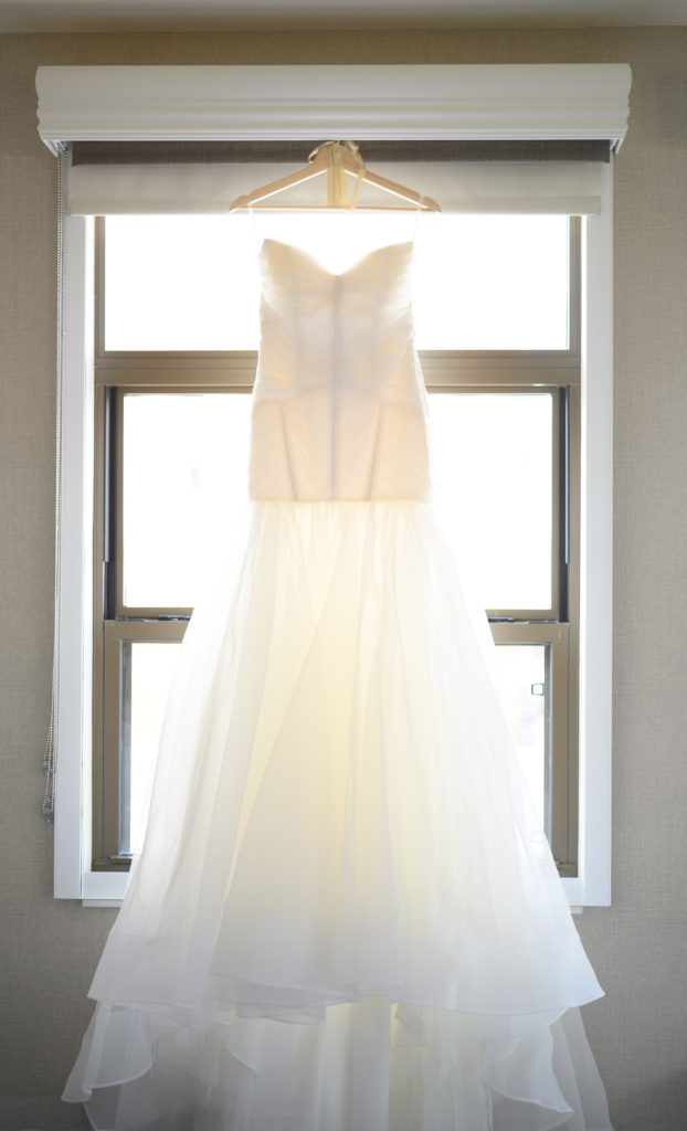 dress hanging in window maryland wedding planner statuesque events
