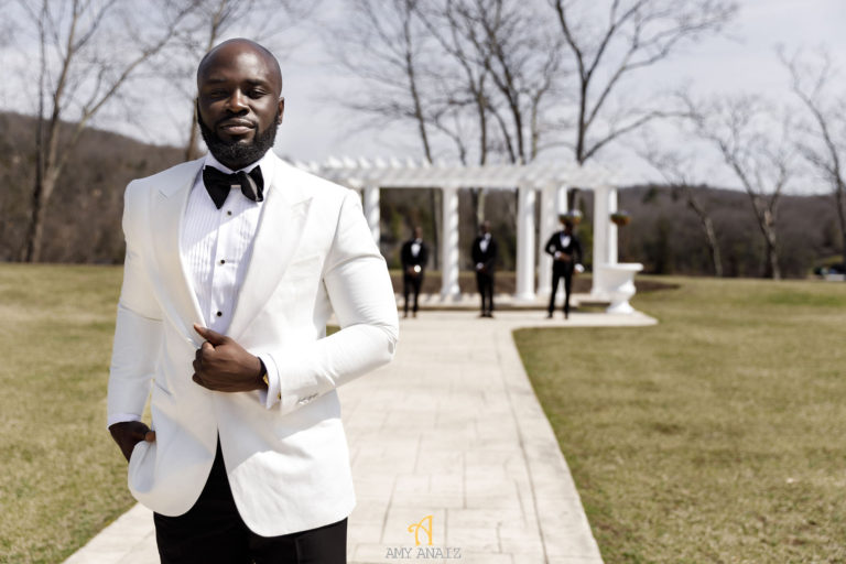 groom in white jacket statuesque events