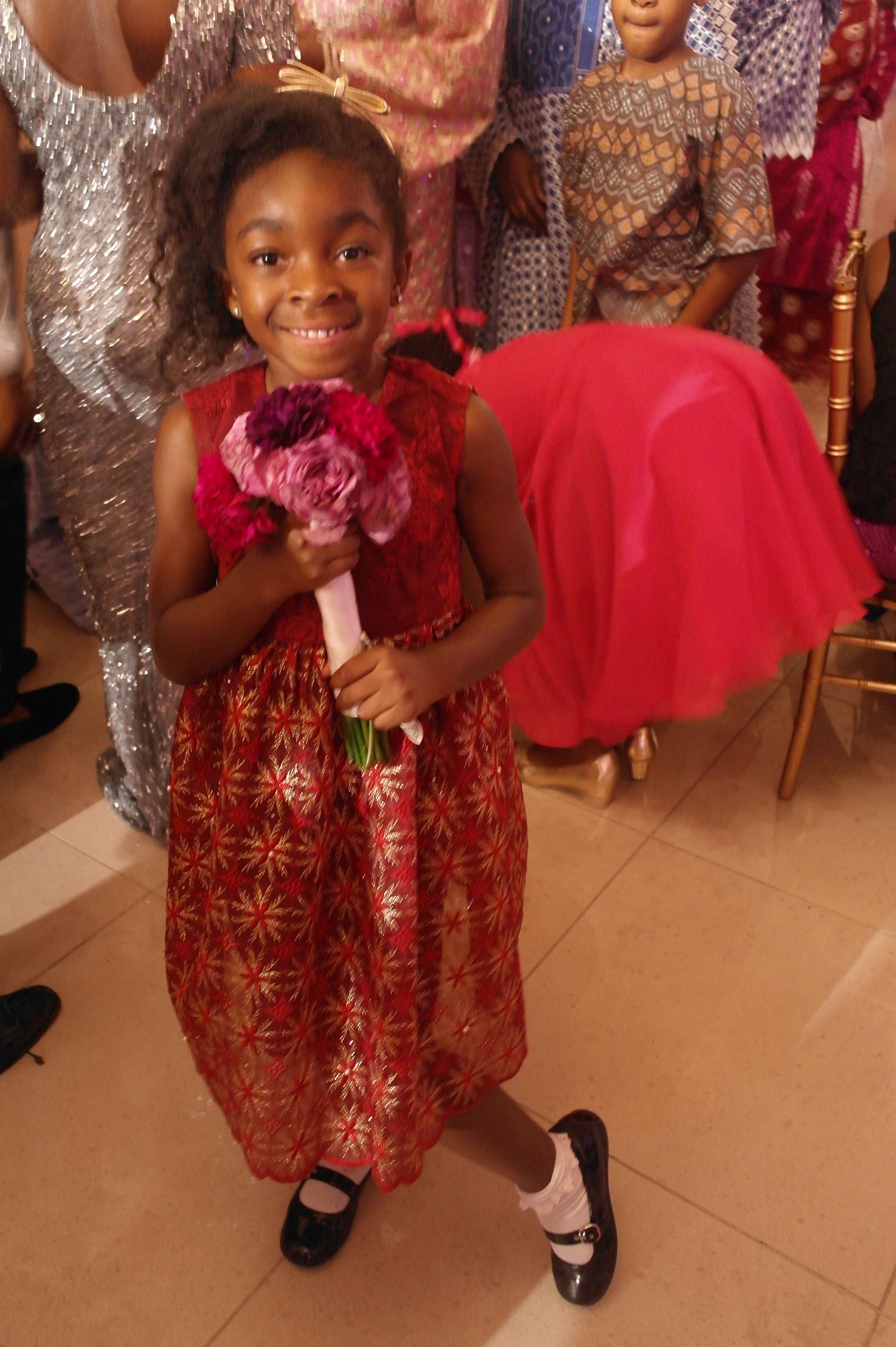 child catching bouquet at wedding